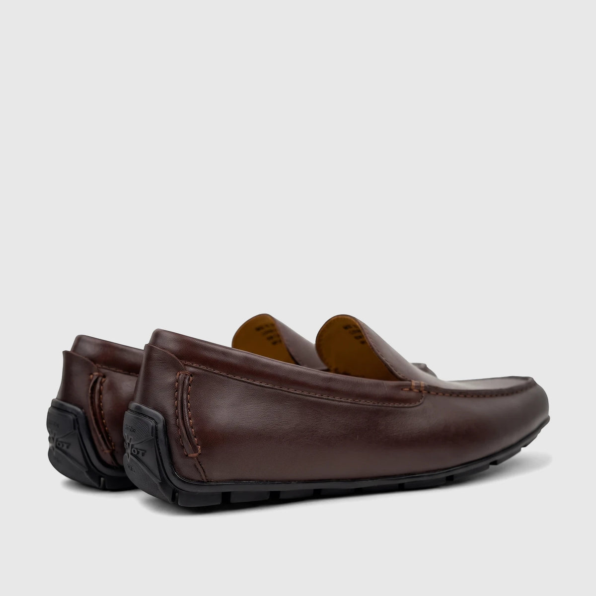 A pair of Florsheim Men's Motor Moc loafers in dark brown leather, shown from a low side angle.
