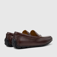 A pair of Florsheim Men's Motor Moc loafers in dark brown leather, shown from a low side angle.