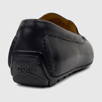 Black leather Florsheim Men's Motor Moc loafer, shown from the back/heel view, highlighting the 'DRIVER PIVOT' sole detail.