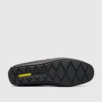 Black Florsheim Men's Motor Moc loafer sole with Comfortech technology and brand logo, isolated on a white background.