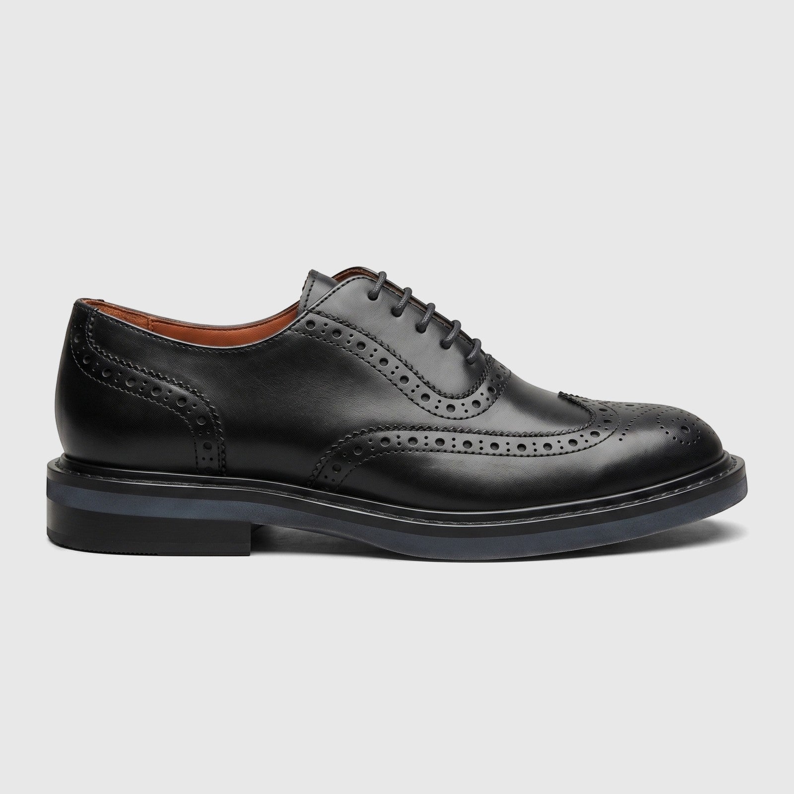Black leather full brogue wingtip lace-up formal shoe for women, detailed with classic perforations and a sturdy sole.