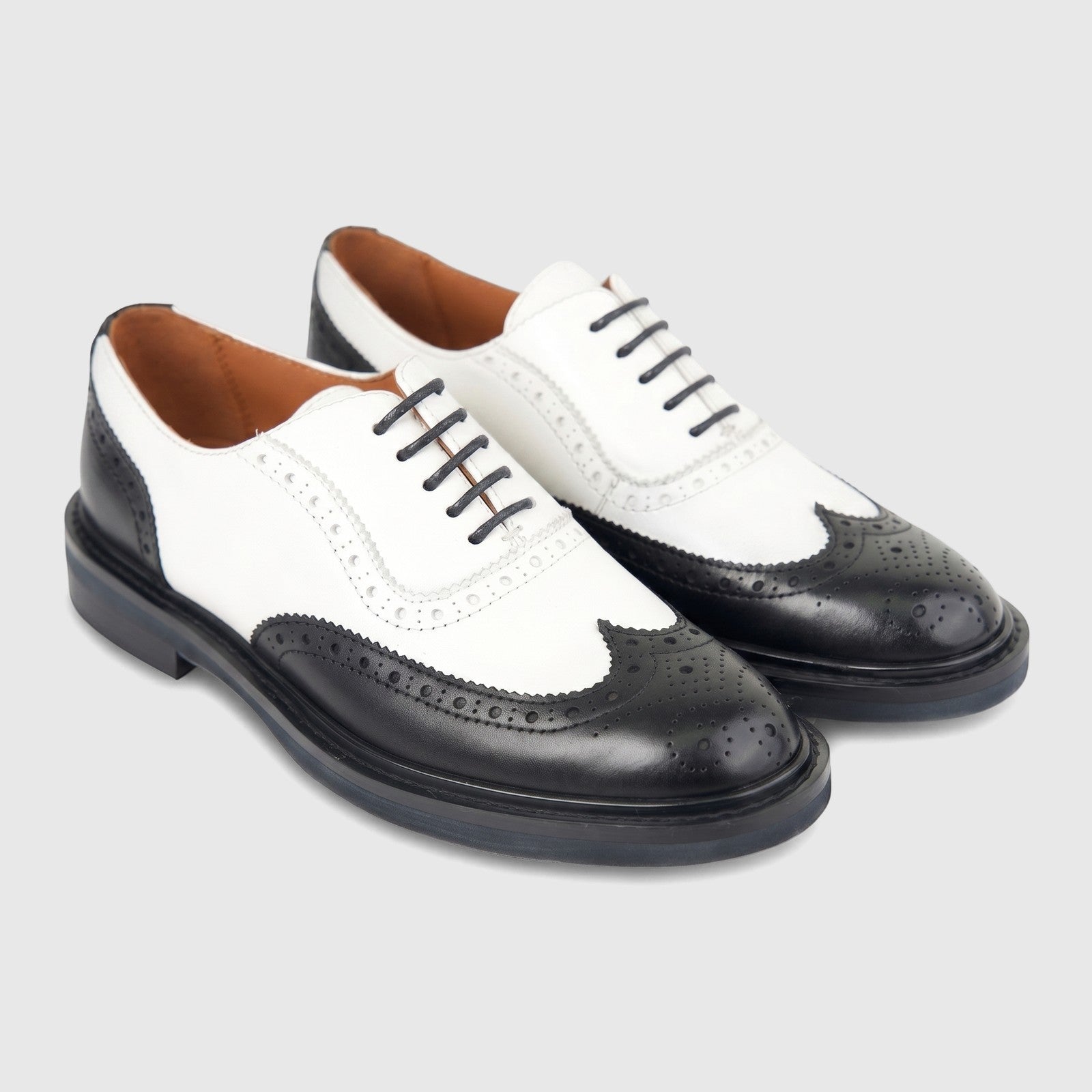 Pair of Formales ladies' black and white leather full brogue wingtip lace-up shoes displayed on a white surface.
