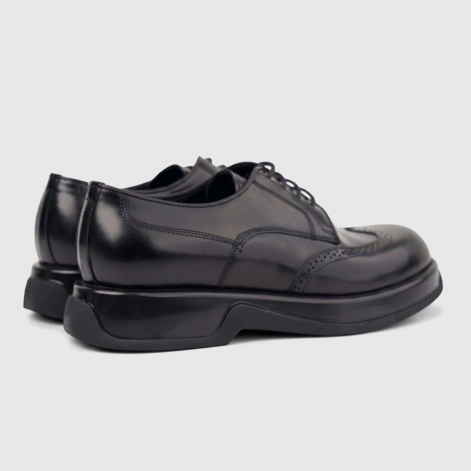 Formale men's black hi-shine leather chunky sole lace-up shoes, viewed from a rear-side angle on a white background.