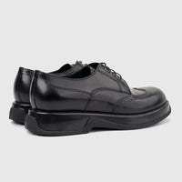 Formale men's black hi-shine leather chunky sole lace-up shoes, viewed from a rear-side angle on a white background.
