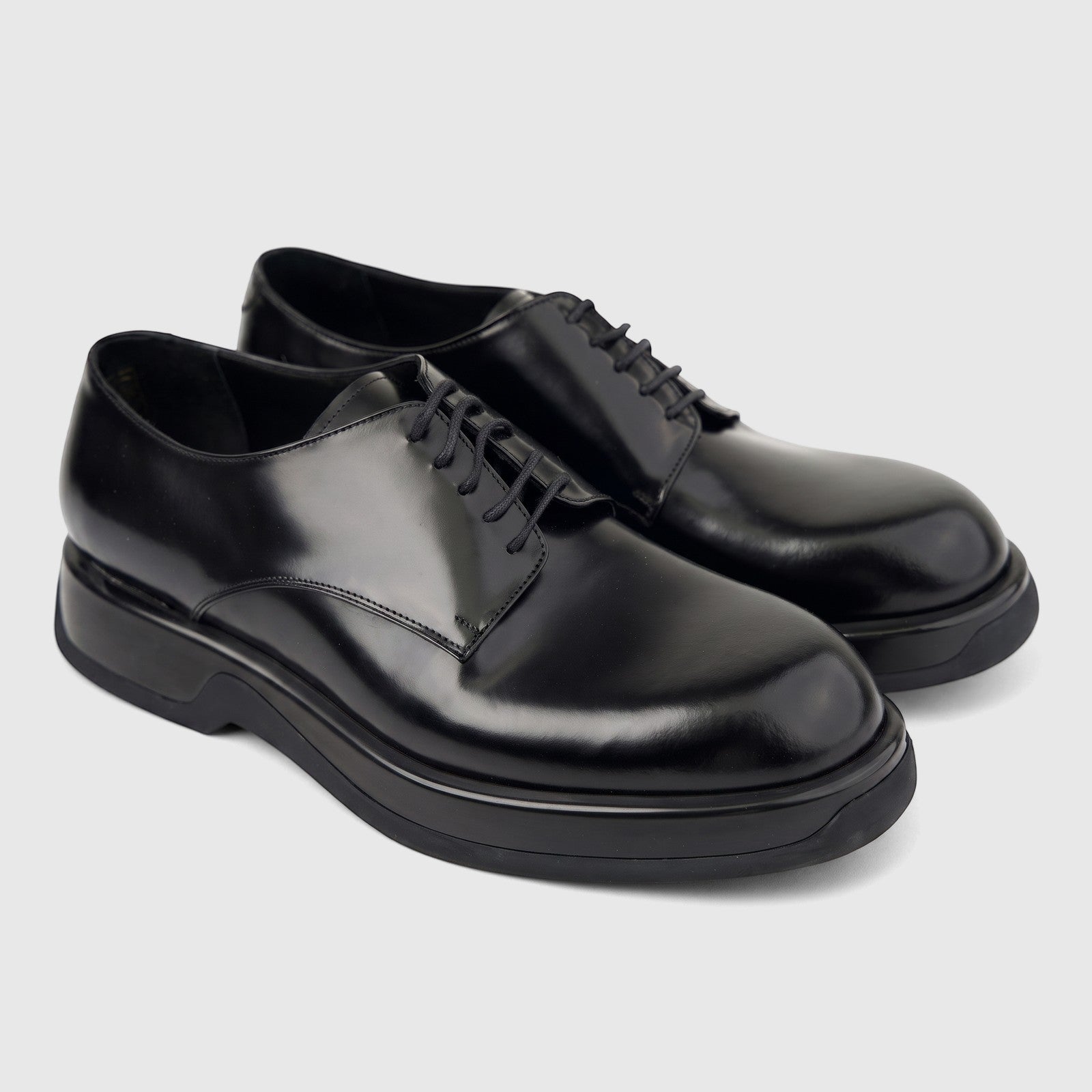 Formales Men's black hi-shine leather lace-up shoes with chunky soles, visible from a side-front view, pair shown on white