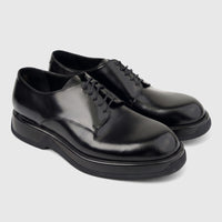 Formales Men's black hi-shine leather lace-up shoes with chunky soles, visible from a side-front view, pair shown on white