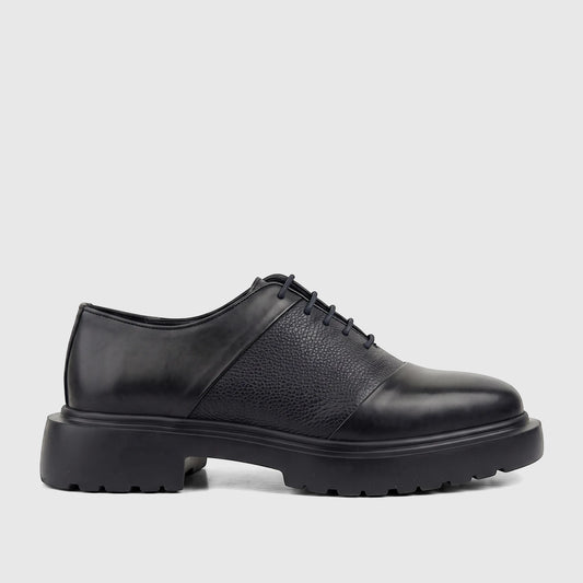 Men's Formales black leather lace-up shoe with a chunky lug sole, featuring both smooth and textured panels, viewed from the