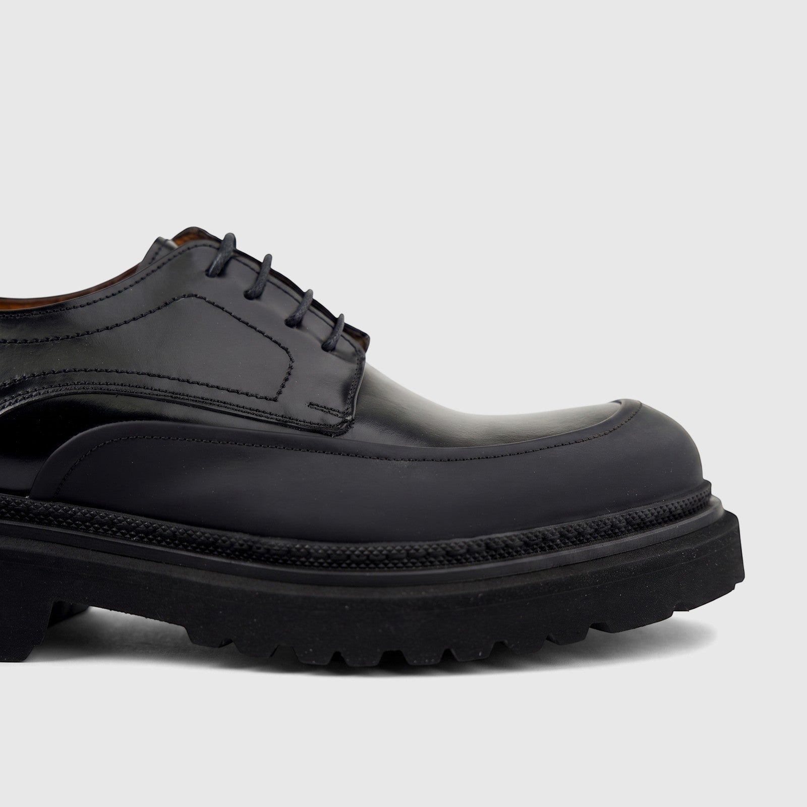 Close-up of a Formale's men's black leather chunky sole lace-up shoe with detailed stitching and thick rubber sole.