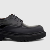 Close-up of a Formale's men's black leather chunky sole lace-up shoe with detailed stitching and thick rubber sole.