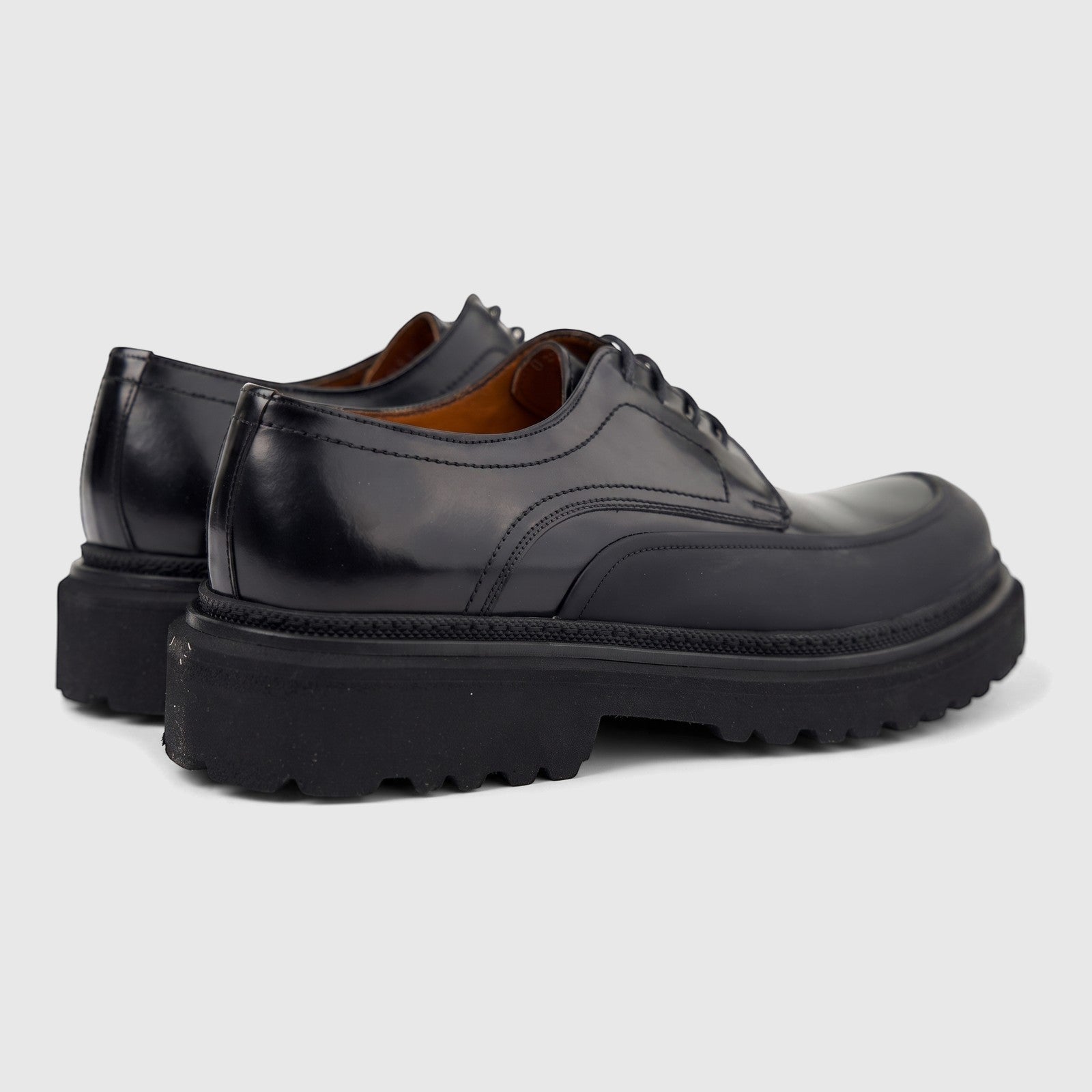 Formales Men's black leather chunky sole lace-up shoes, featuring a glossy finish and a rugged sole, shown from a side-back