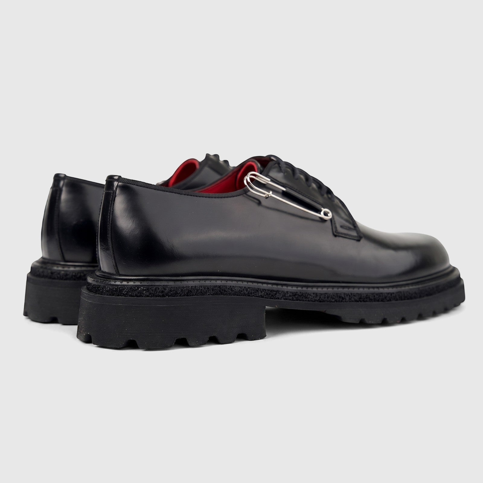 Formales men's black leather lace-up shoes with chunky lug soles and a silver safety pin detail.