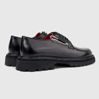 Formales men's black leather lace-up shoes with chunky lug soles and a silver safety pin detail.