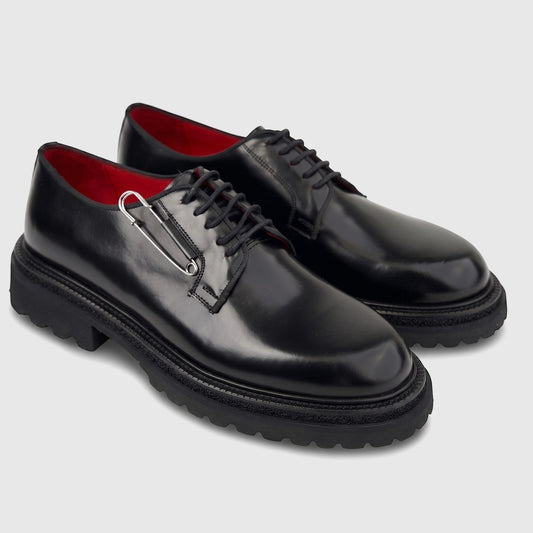 Formale's Men's black leather lace-up shoe with a chunky lug sole and a silver safety pin detail, shown in a side profile