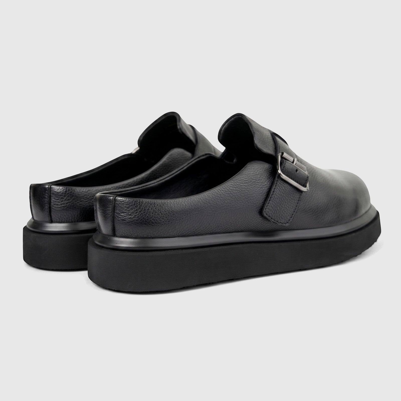 Formals Men's Black Leather Chunky Sole Mules, shown from a side-rear view, featuring a silver buckle and pebbled texture.