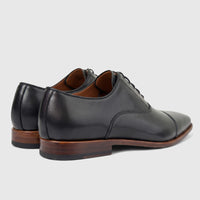Formales Men's black leather dress lace-up shoes, shown from a rear-side view with brown soles.