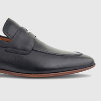 Formales men's black leather dress slip-on loafer, shown from the side view with textured leather and a brown sole.