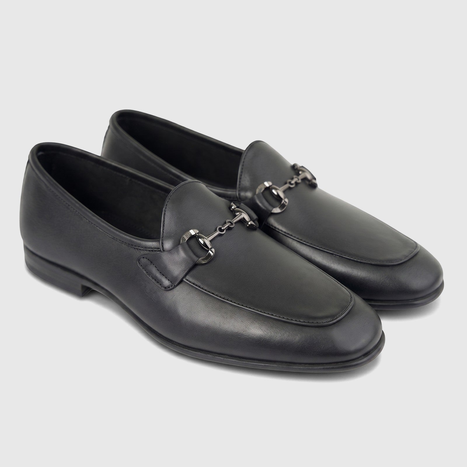 A pair of Formales men's black leather loafers with silver-toned horsebit buckles, presented from a slightly elevated angle.
