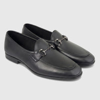 A pair of Formales men's black leather loafers with silver-toned horsebit buckles, presented from a slightly elevated angle.
