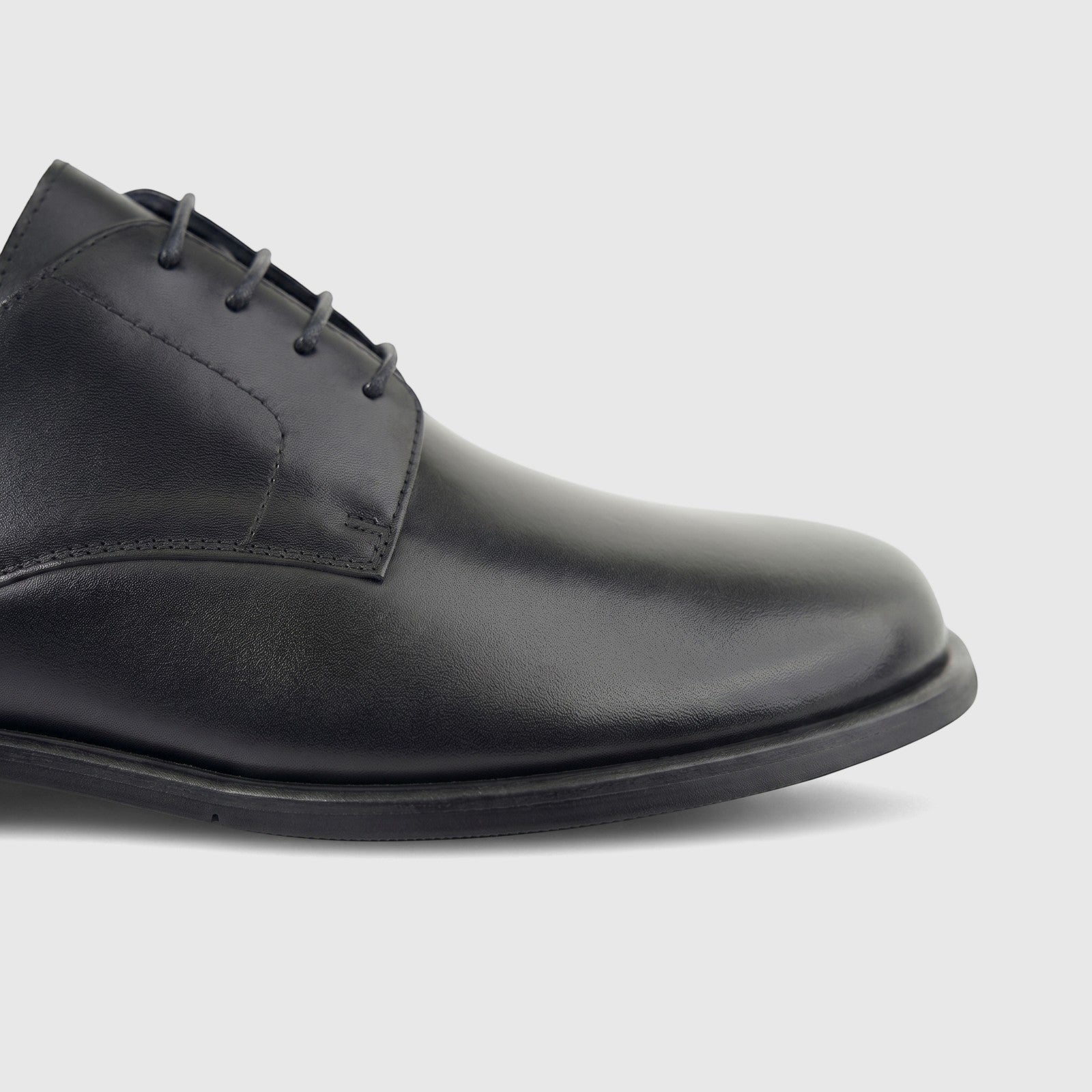 A close-up profile shot of a Formales men's black leather lace-up formal shoe, highlighting the texture and laces.