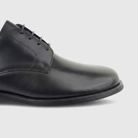 A close-up profile shot of a Formales men's black leather lace-up formal shoe, highlighting the texture and laces.