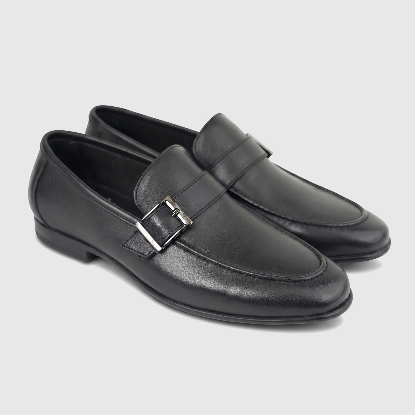 Formales Men's black leather loafer shoes with a silver-tone buckle, presented from a high angle view on a plain white
