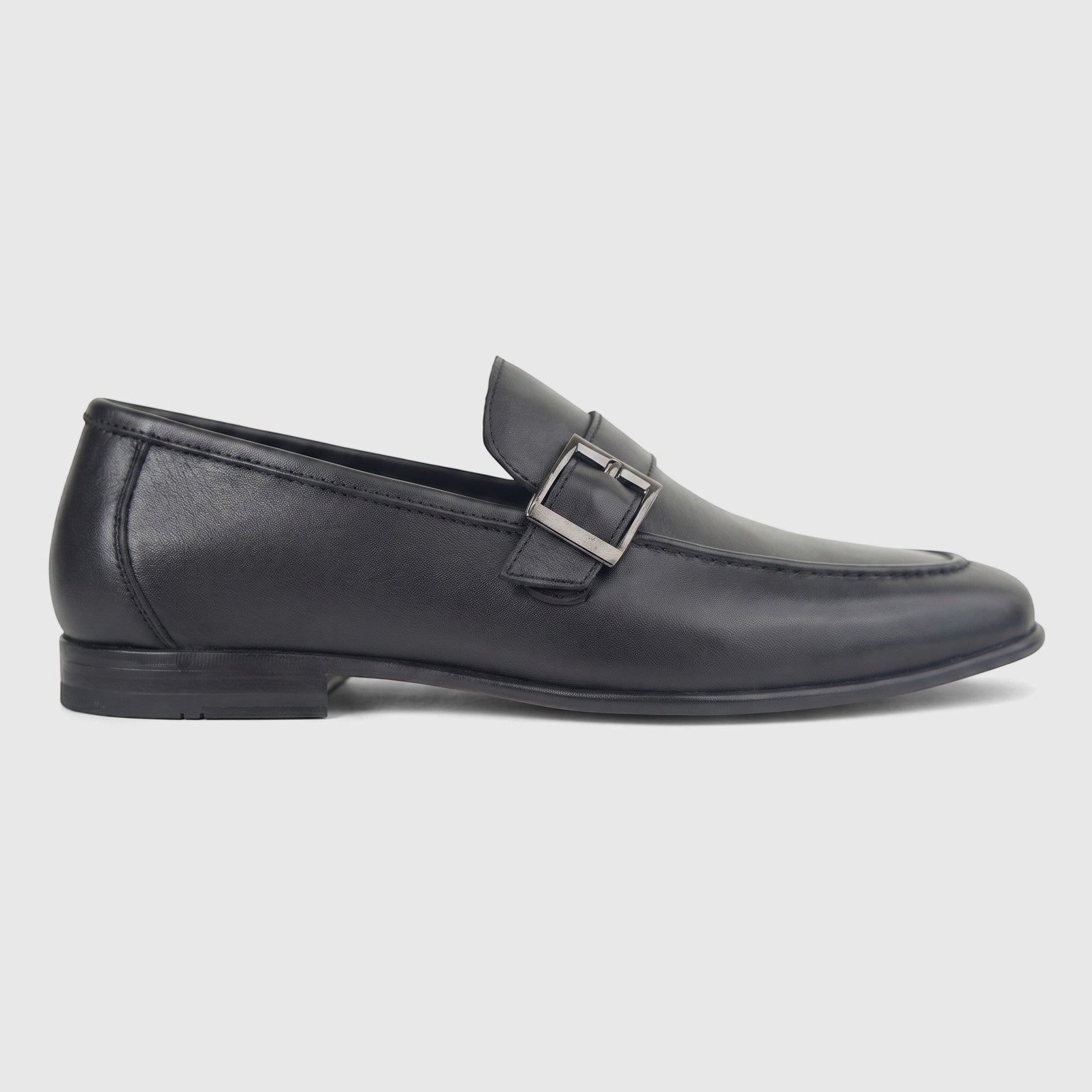 Formale's Men's black leather loafer with a silver buckle, viewed from the side profile against a a plain white background.