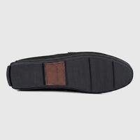 Bottom view of a Formales Men's Black Leather Loafer, showcasing the patterned rubber sole with a branded brown leather