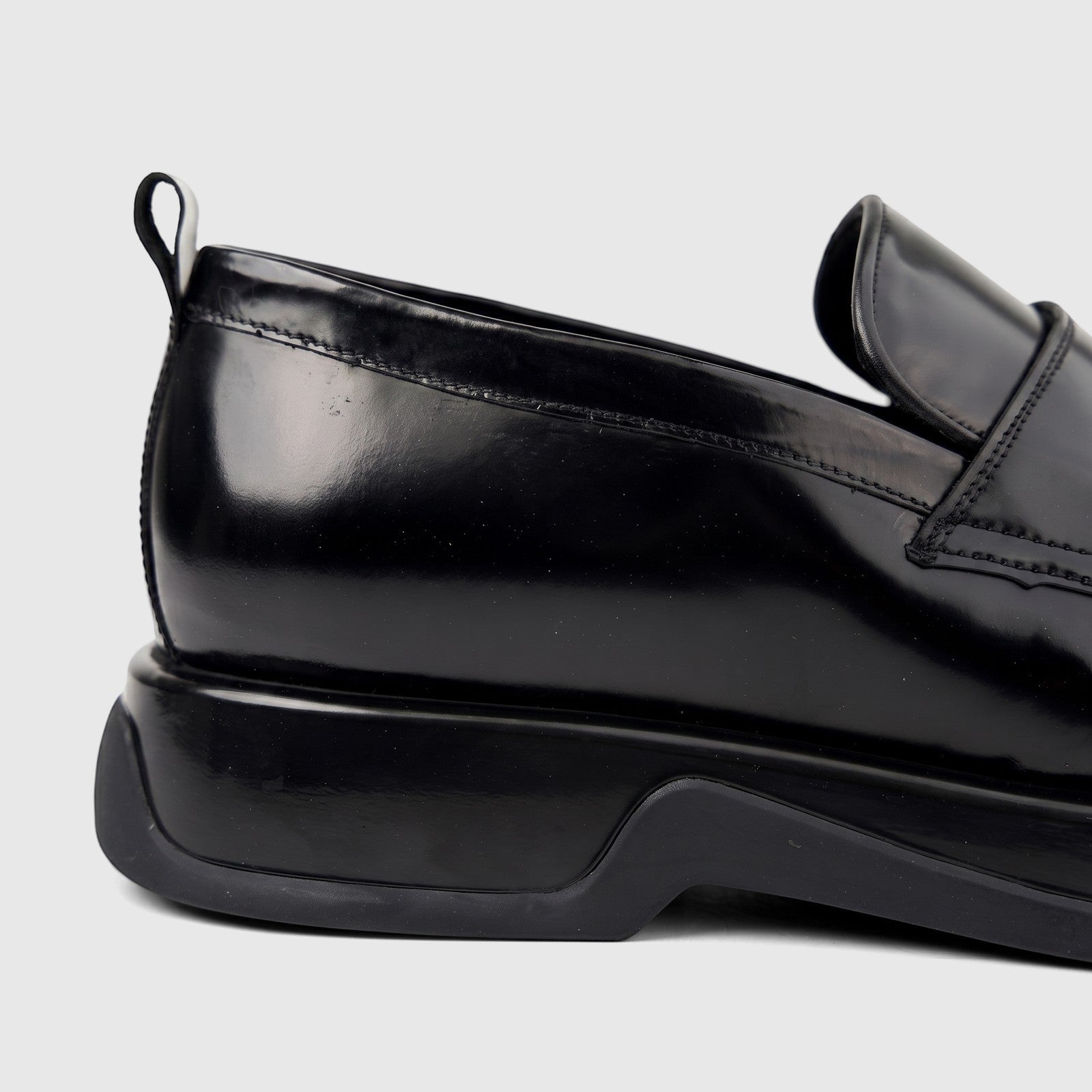 Close-up side view of a Formales Men's black patent leather loafer with a chunky sole.