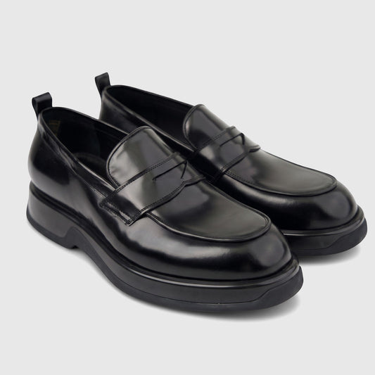 Black high-shine formal men's slip-on loafer with a chunky sole, presented in a side profile view.