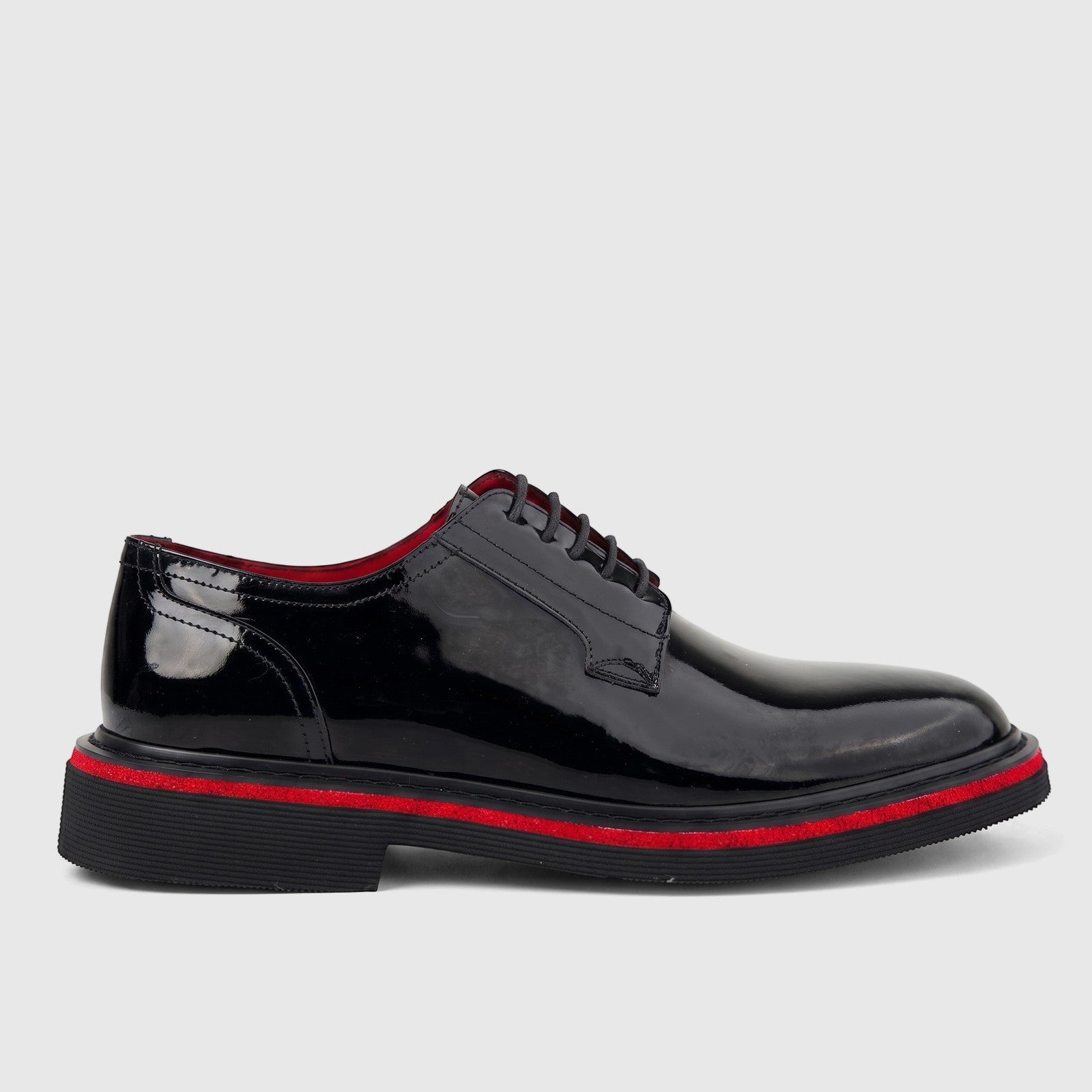 Formales Men's black patent leather lace-up shoe with a chunky red-striped sole, side view.
