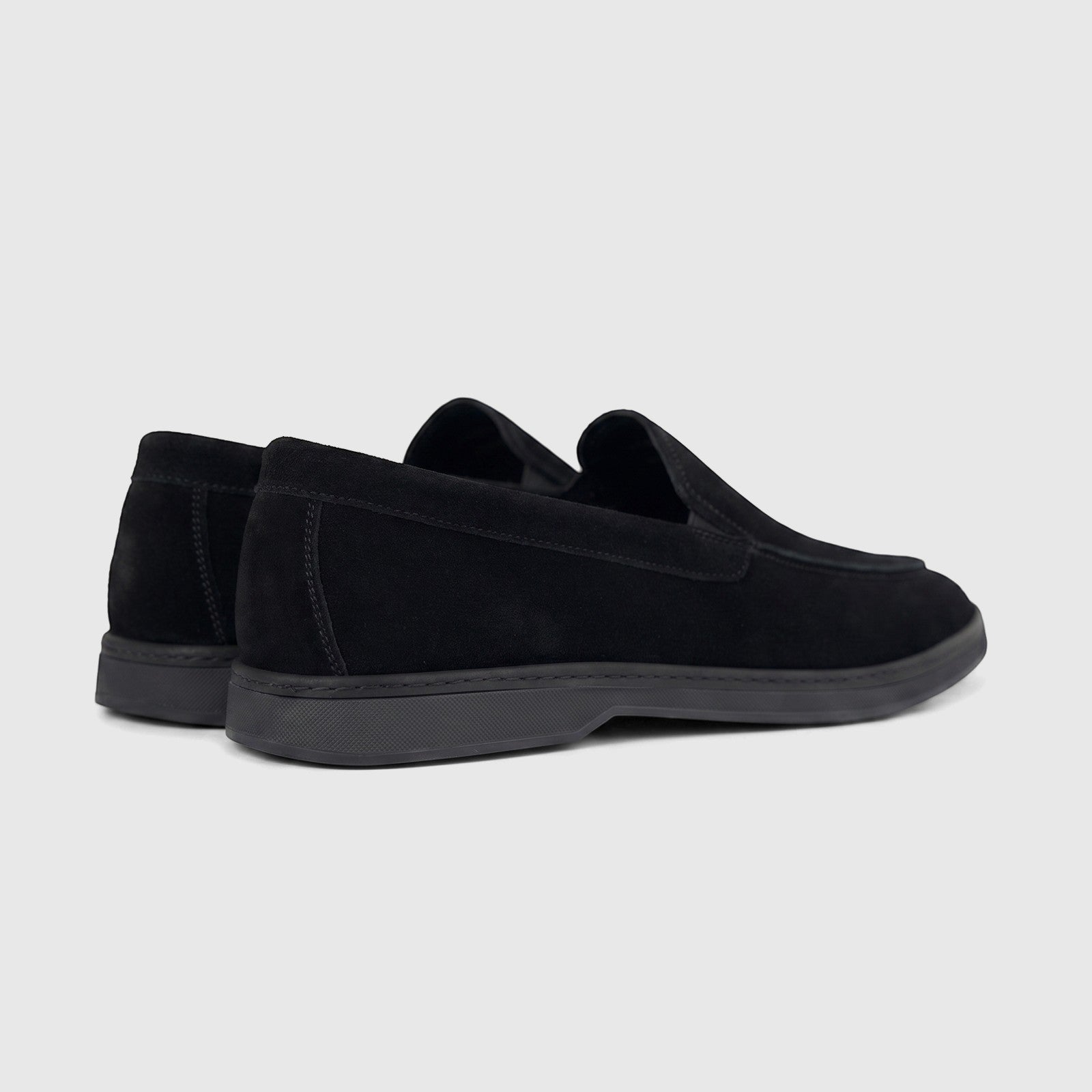 Rear-side view of Formales men's black suede leather loafers with rubber soles, showcasing their classic slip-on design.