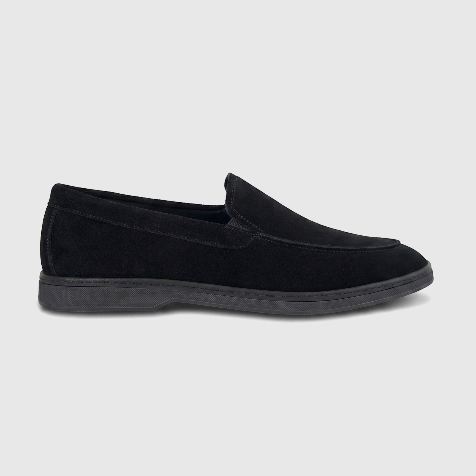 Black suede men's loafer shoe in a side profile, featuring a clean silhouette and detailed stitching, suitable for formal or