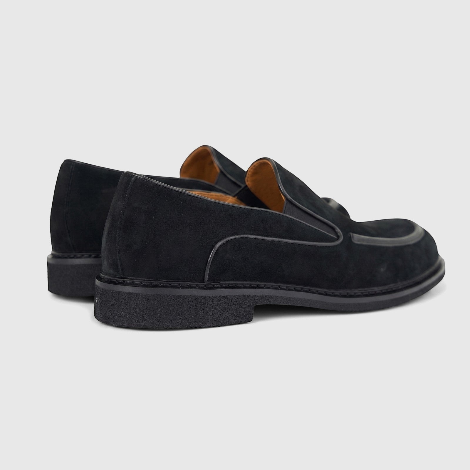 Formales men's black suede slip-on loafers with chunky black soles, captured from a rear side view.