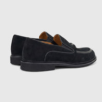 Formales men's black suede slip-on loafers with chunky black soles, captured from a rear side view.