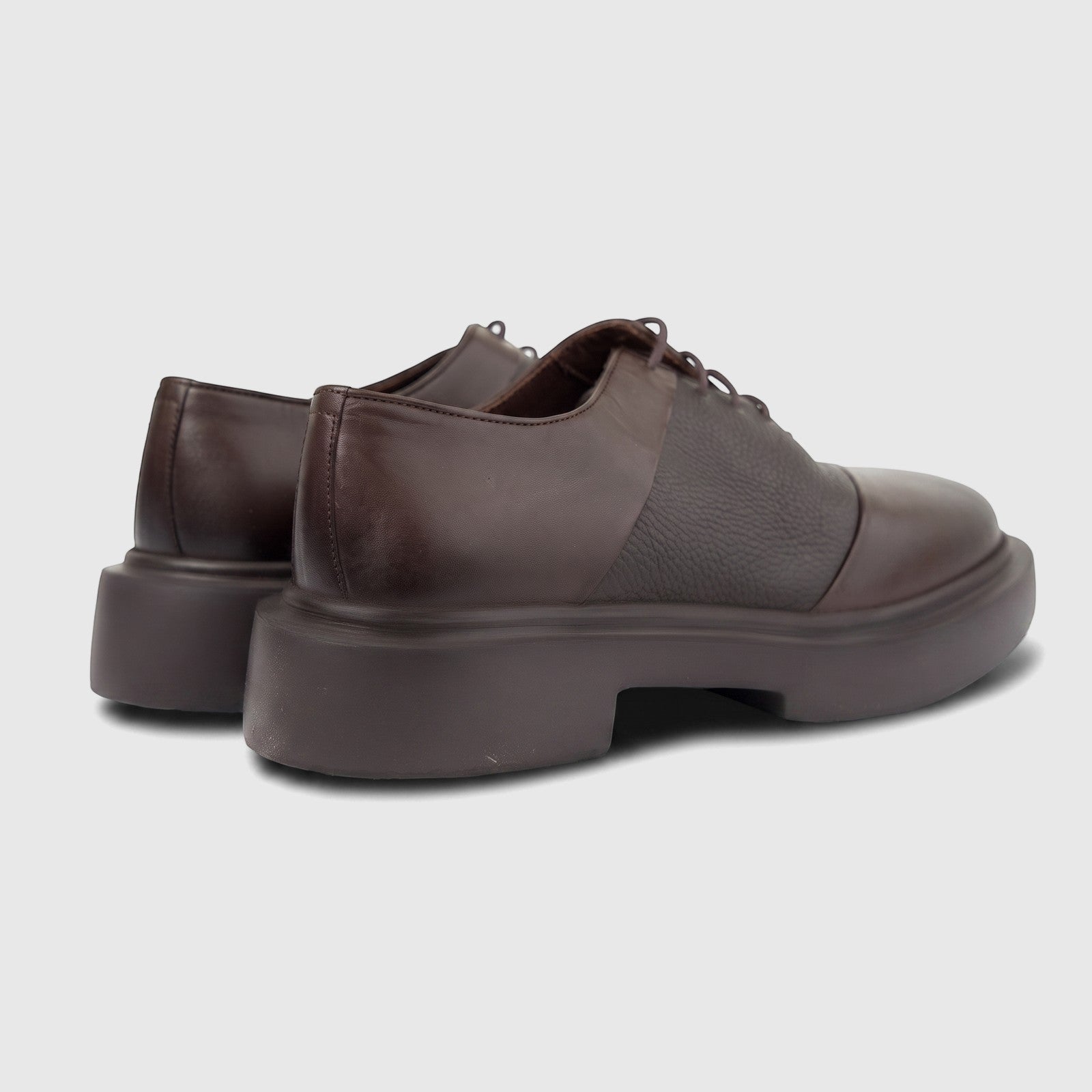 Pair of Formale's men's brown leather chunky sole lace-up shoes, shown from a rear and side view on a white background.