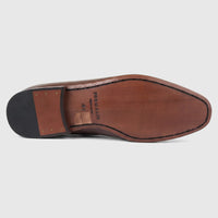 Bottom view of a Formales men's coffee brown leather dress slip-on shoe, showcasing the leather sole with black stitching,