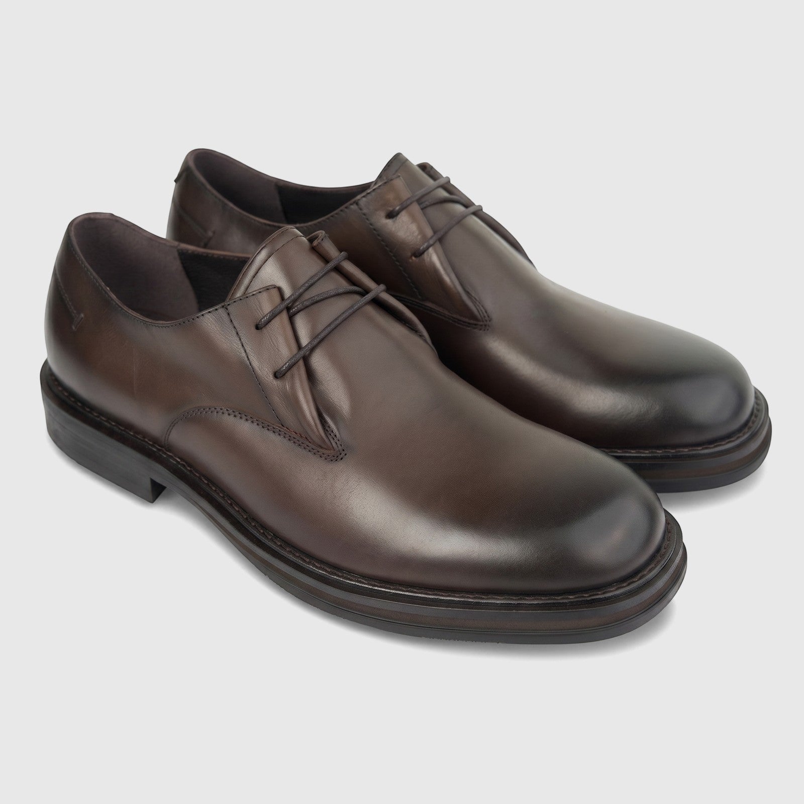 A pair of Formales men's coffee brown leather lace-up derby shoes with a chunky sole, presented on a white studio background.