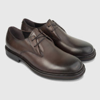 A pair of Formales men's coffee brown leather lace-up derby shoes with a chunky sole, presented on a white studio background.