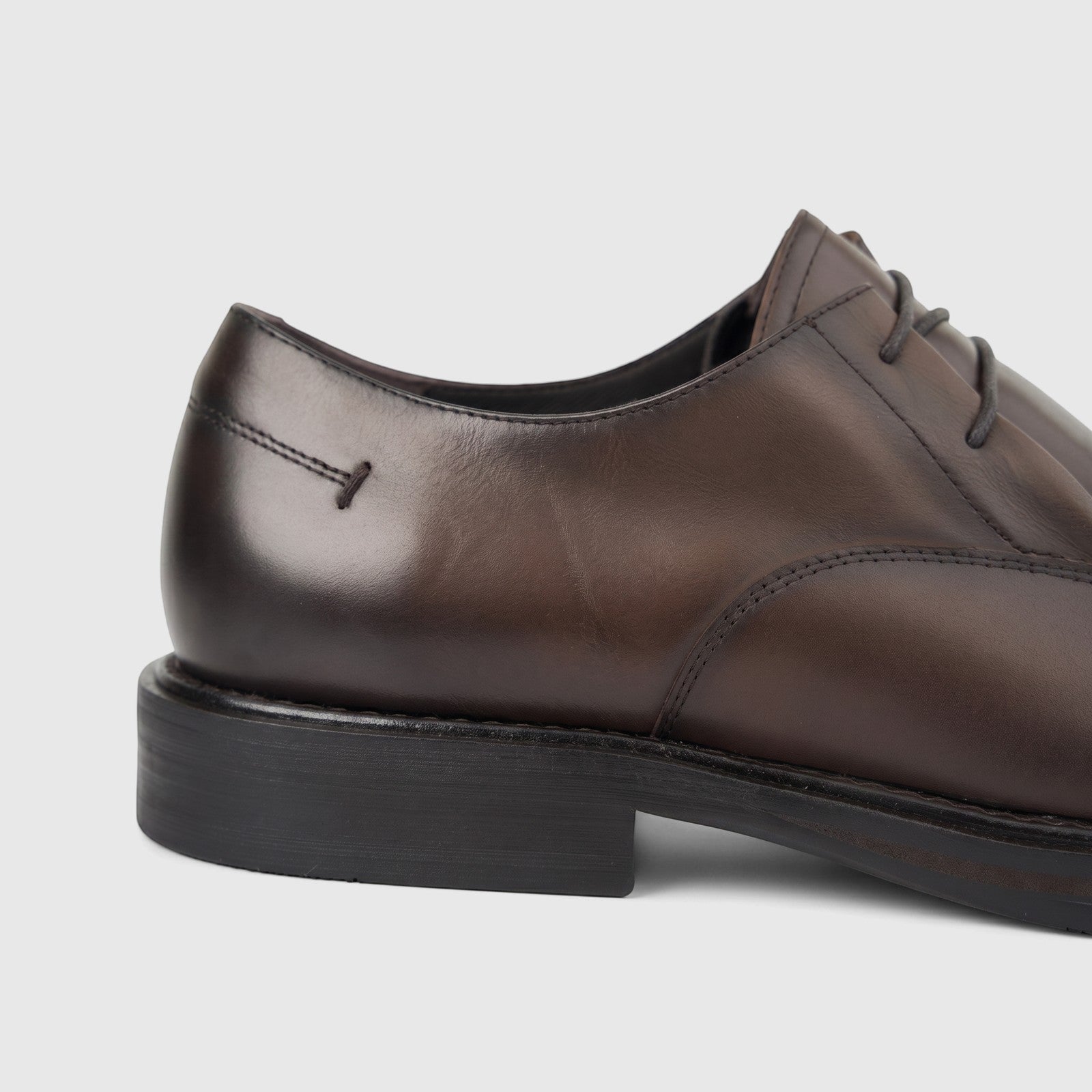 Close-up side view of a Formales men's coffee brown leather shoe with a chunky sole and visible laces.
