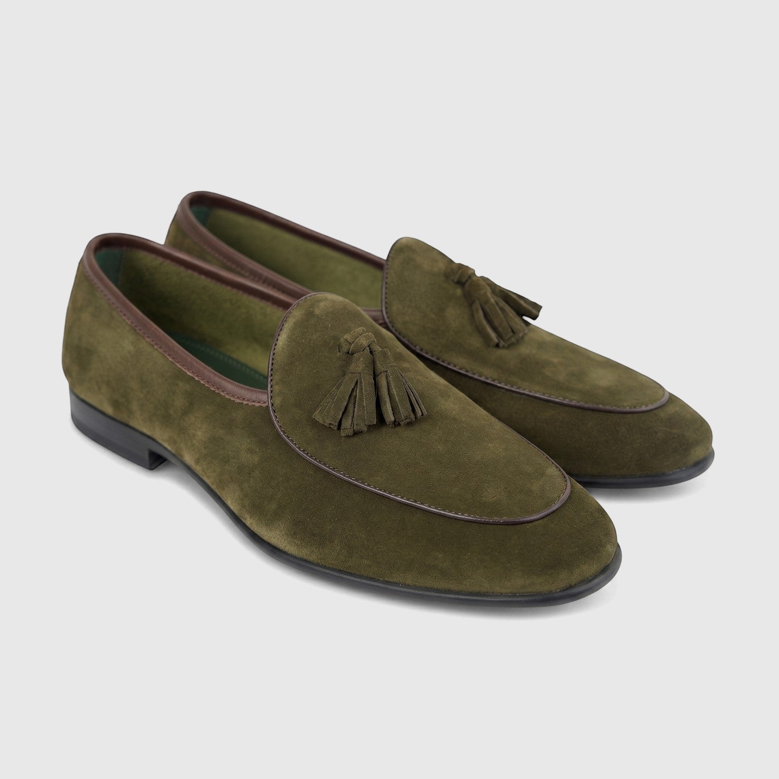 Pair of Formales Men's FT268003 green suede tassel loafers, featuring dark brown trim and black soles, presented on a white