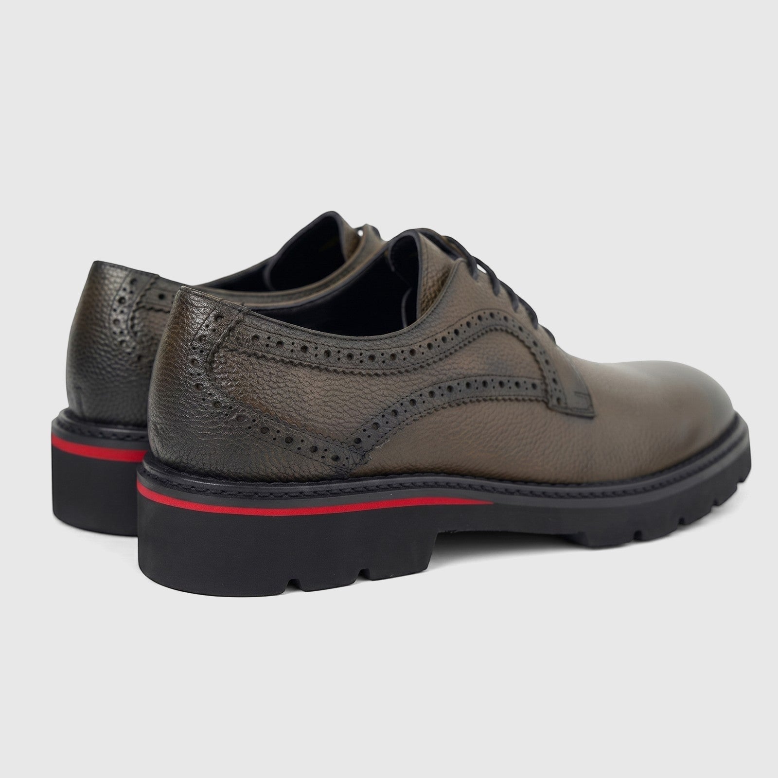A pair of Formales men's leather chunky sole lace-up shoes in khaki, featuring brogue detailing and a black sole with a red