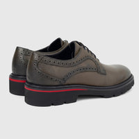 A pair of Formales men's leather chunky sole lace-up shoes in khaki, featuring brogue detailing and a black sole with a red