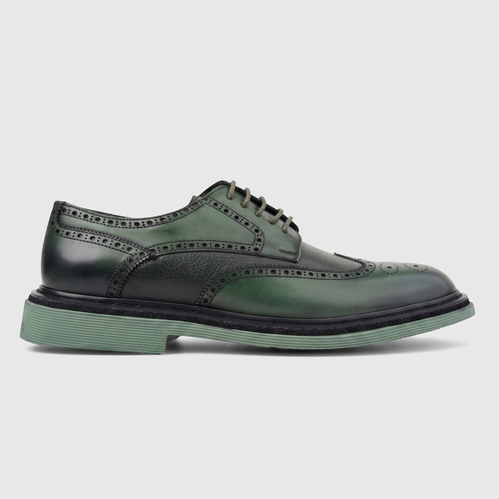 Green leather men's brogue shoe with chunky sole and lace-up design, shown in a side profile view.