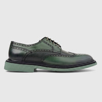Green leather men's brogue shoe with chunky sole and lace-up design, shown in a side profile view.