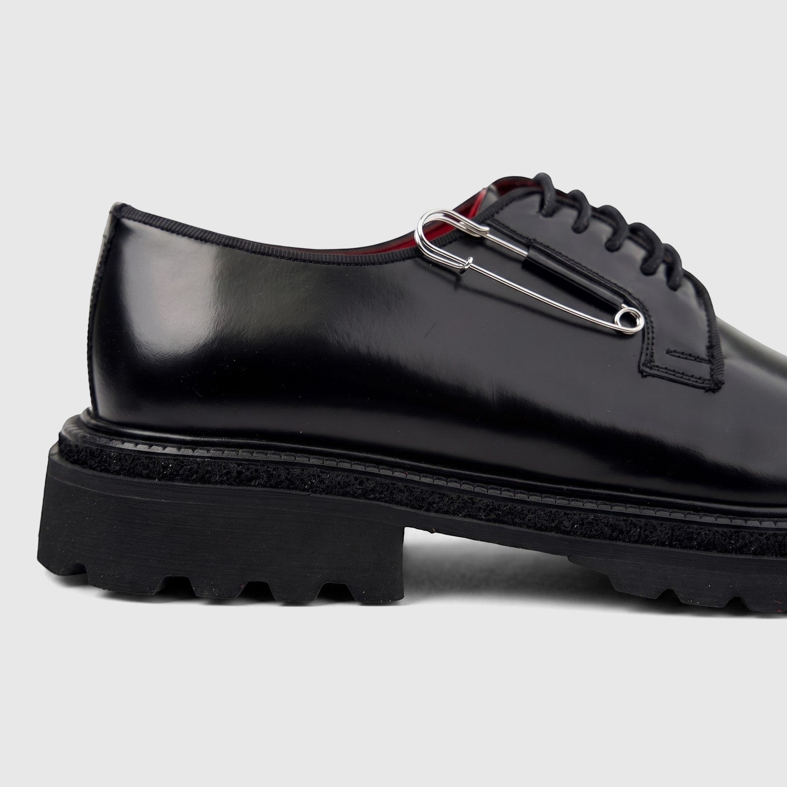 Formales men's black leather lace-up shoe with a chunky sole, featuring a silver safety pin detail, viewed from the side.