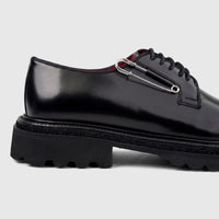 Formales men's black leather lace-up shoe with a chunky sole, featuring a silver safety pin detail, viewed from the side.