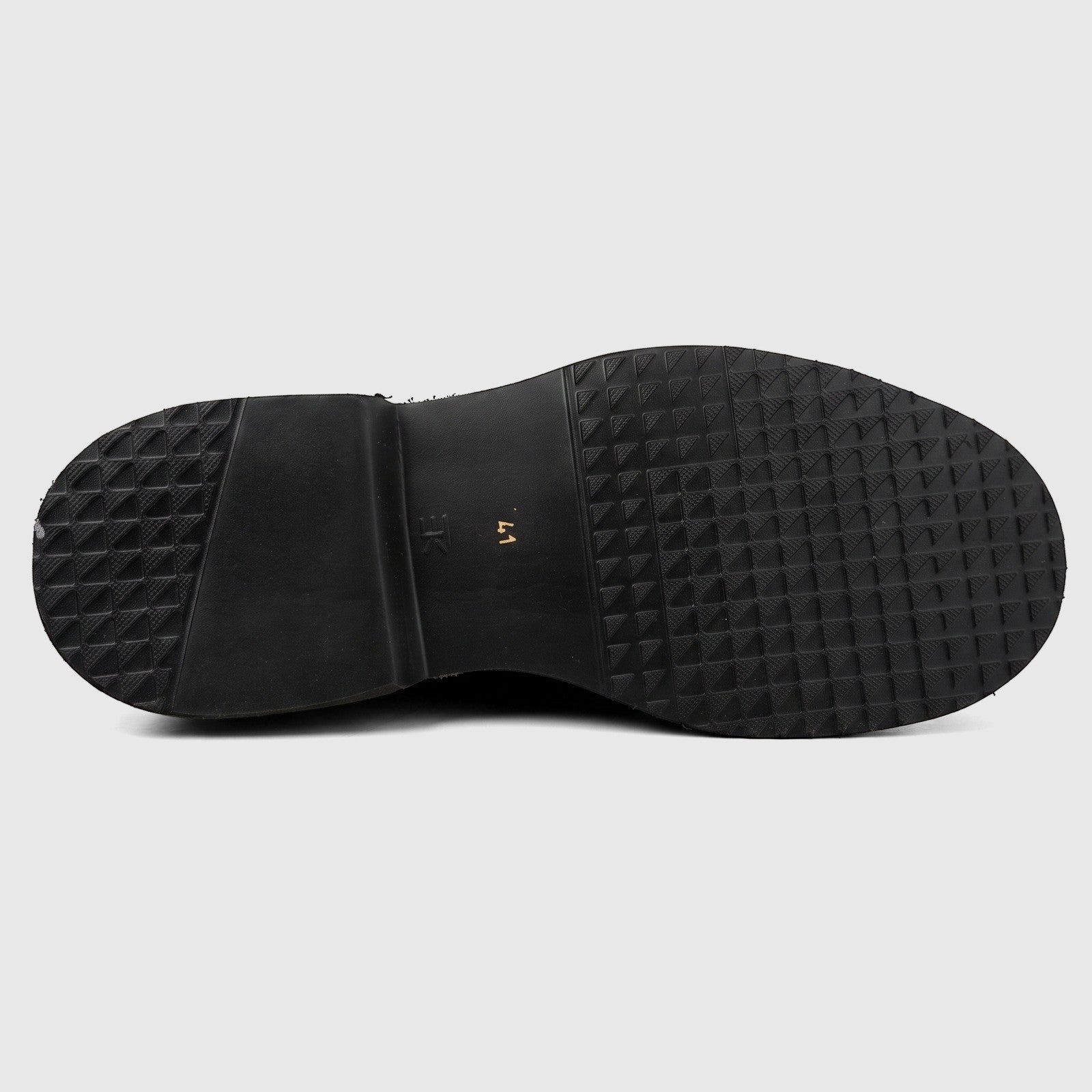 Black formal men's shoe with a chunky rubber sole, featuring a textured tread pattern and size 41 marking.