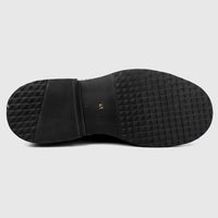 Black formal men's shoe with a chunky rubber sole, featuring a textured tread pattern and size 41 marking.