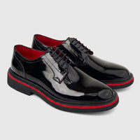 Pair of Formale Men's black patent leather lace-up shoes with chunky soles and red accents.