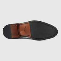 Bottom sole of Formales men's black leather dress shoe, featuring a chunky black rubber front and a brown leather heel. Size